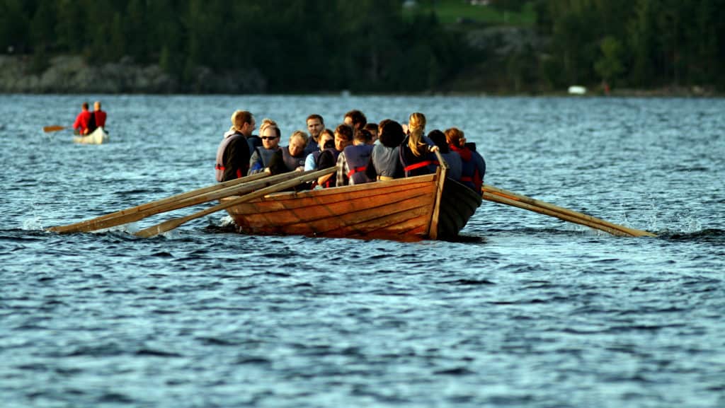 Many people row a church boat.